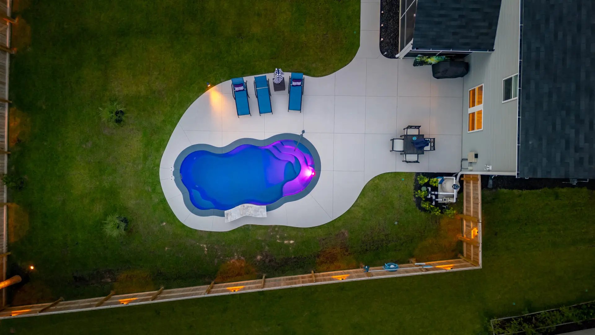 Glowing freeform fiberglass pool, Heritage Pools project